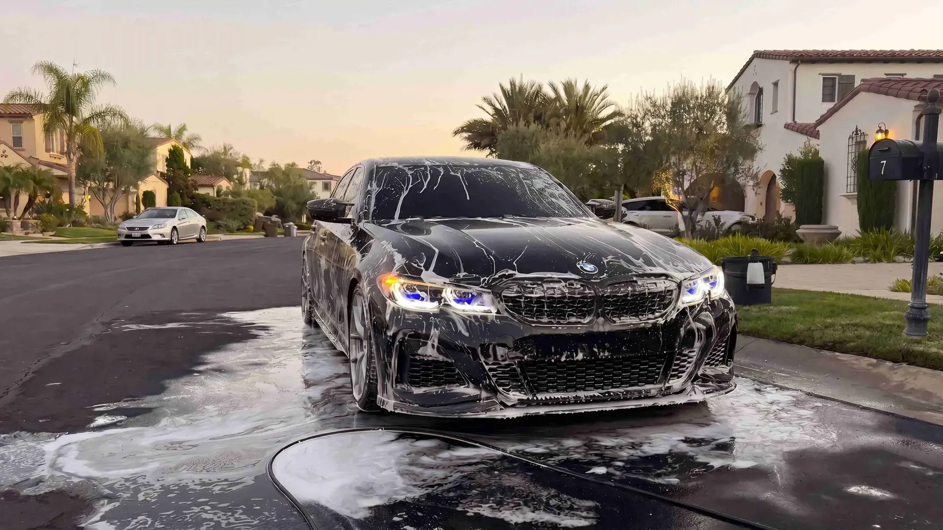 Vehicle being washed down by hand with a pressure washer
